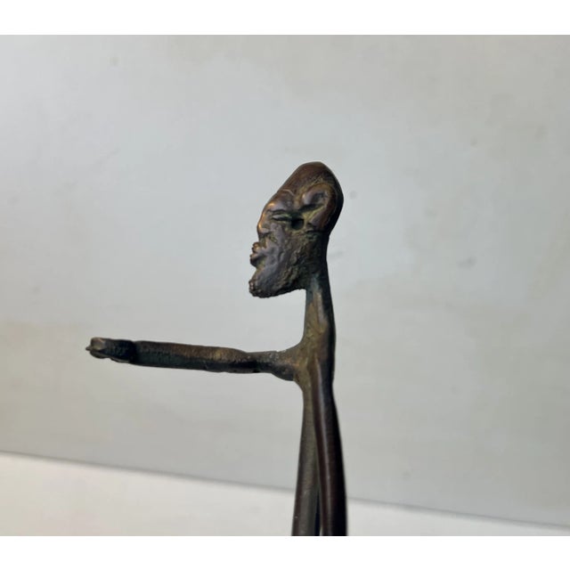 Unusual vintage African bronze sculpture. It depicts a naked man/tribes man with stretched arm. I was brought from Africa...
