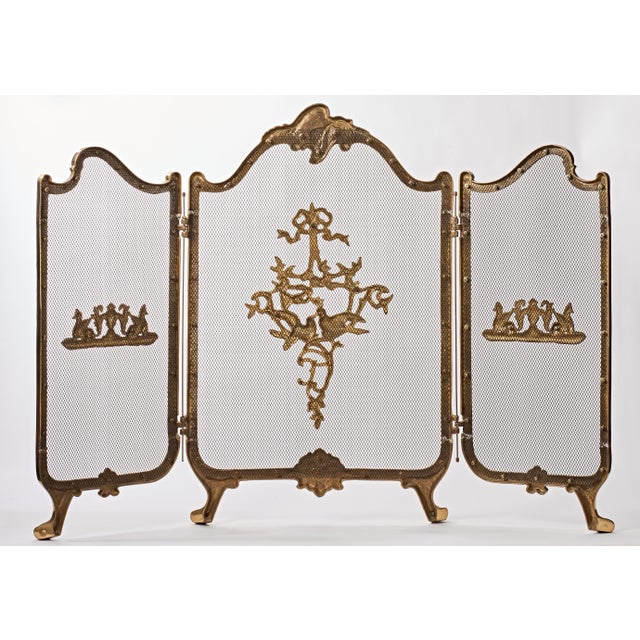 Beautiful vintage solid brass fire screen. Brass details have pair of Griffins in heraldic pose on each side panel and in...