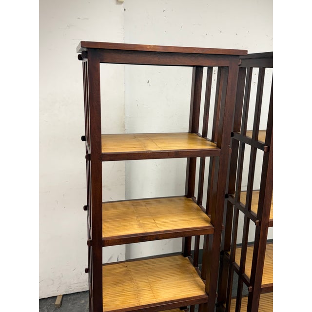 Design Plus Gallery presents a Pair Asian Style Split Bamboo Étagère Bookcase. This coordinating pair has deep brown wood...