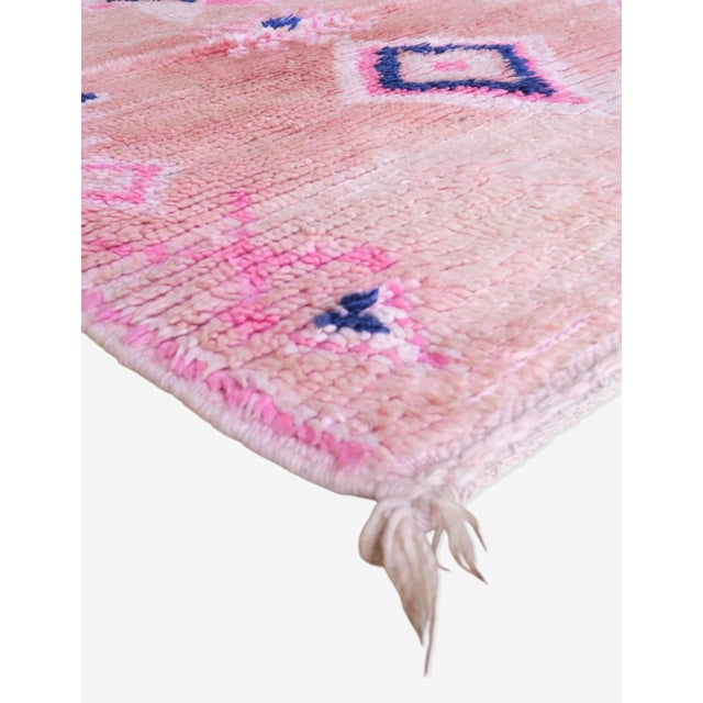 Get cozy with this Pink Moroccan Runner Wool Rug! Measuring 9.1 x 3.3 ft, this rug adds a touch of warmth and comfort to...