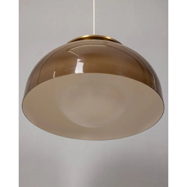 Suspension chandelier with brown and white plastic lampshade and golden metal upper insert, design Luigi Massoni for...