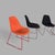 a striking set of four mid-century stackable egg dining chairs upholstered in contrasting orange and black fabric. Their...