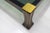 This coffee table is made of walnut with brass trim and a smoked glass top. This model is part of the "Ussaro" collection...