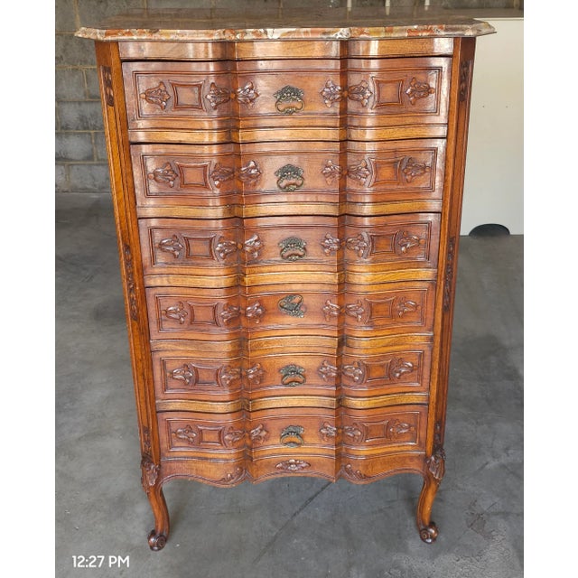 An exceptional carved Provincial Style Walnut And Breche D’Alep Marble Top Chest Of Drawers with clean lines. Measures 33"...