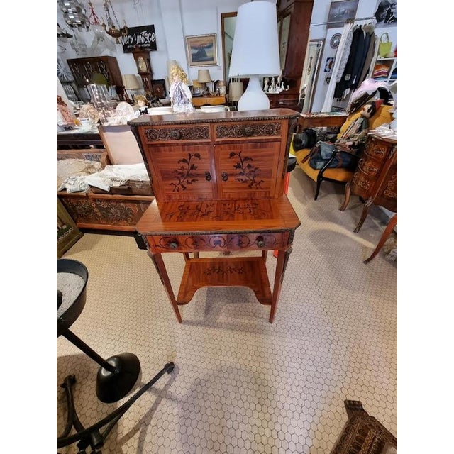 Elegant cherry writing desk with wood inlays and bronze decorations, upper body with small drawers and lower table top