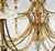 A stunning grand scale chandelier with an Old World Neoclassic elegance. The polished brass has arms featured in a rope...