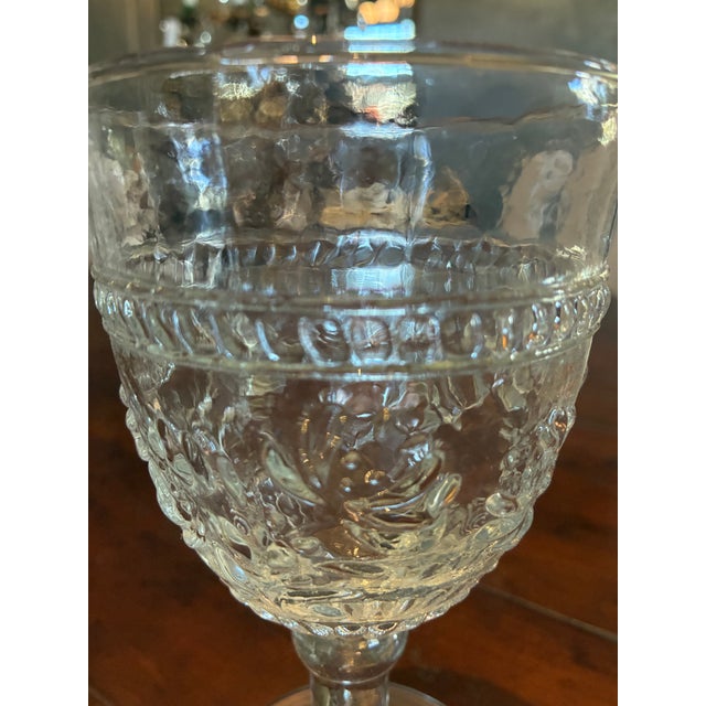 These water goblets feature an ornate, embossed floral design and a textured pattern around the bowl. Round shape with a...