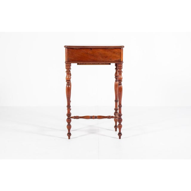 This charming antique sewing table from Holland, circa 1880, is crafted from mahogany wood. It features a lift-top with...
