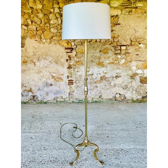 Beautiful, French, vintage floor lamp resting on tripod feet with gilded brass decor, from the 1960's - 70's. Piece...