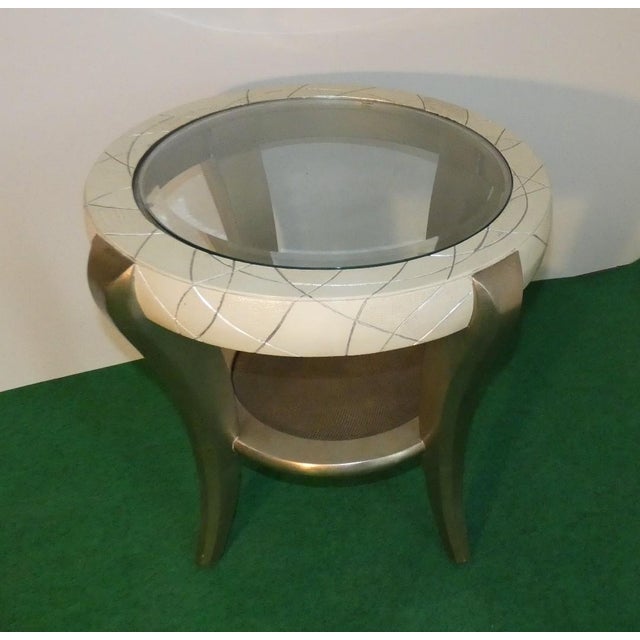 The beech wood coffee table is finished in silver leaf with a beige lacquered top edge. It measures 66 cm in diameter and...