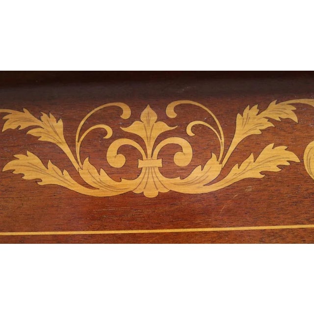 Biedermeier style mahogany center table circa 1900. Rectangular top with two side bands that can be lifted to form a...