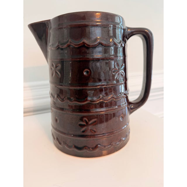 Vintage Mar-Crest Daisy Dot stoneware pitcher in rich Colorado Brown glaze, featuring embossed floral-and-dot motifs with...