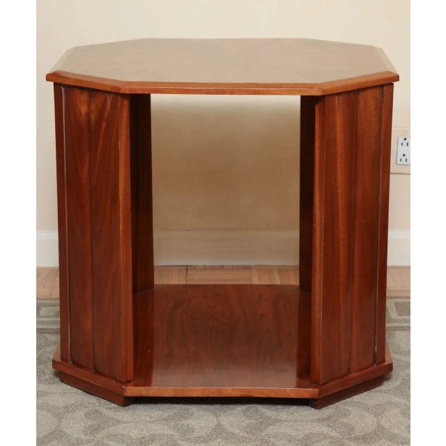 The octagonal top with radiating parquetry inlay; raised on four canted paneled supports joined by a platform stretcher on...