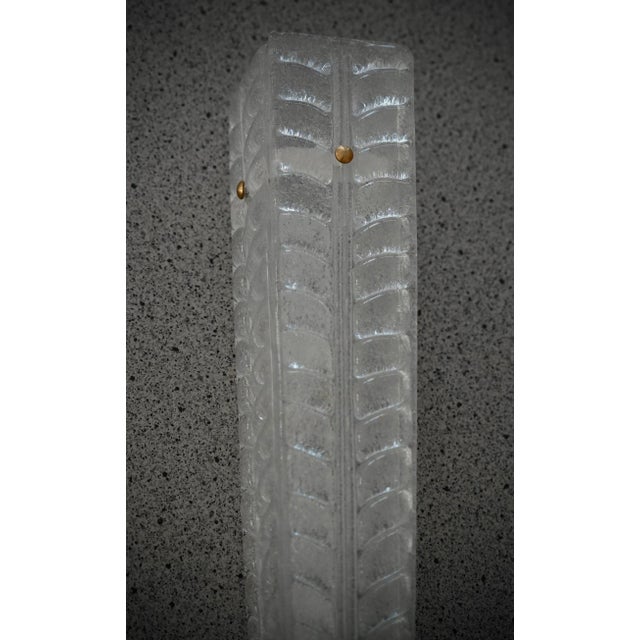 A highly original Murano glass wall light with an elongated design of glass leaves in a unique light sandblasted color....