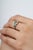 Crafted in 925 sterling silver, this contemporary ring showcases vibrant emeralds totaling 0.87 carats, accented by...