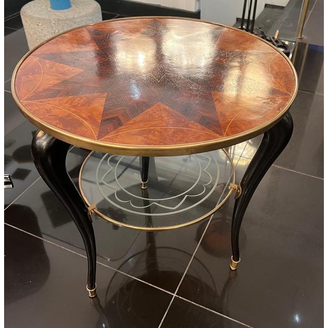 A fabulous Italian two tiered circular side table with beautiful walnut marquetry design on top surrounded by a brass...