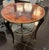 A fabulous Italian two tiered circular side table with beautiful walnut marquetry design on top surrounded by a brass...