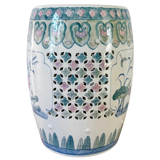 A vibrant green and pink Chinese porcelain garden stool featuring beautiful lotus flowers, dragonflies, cranes, and lucky...