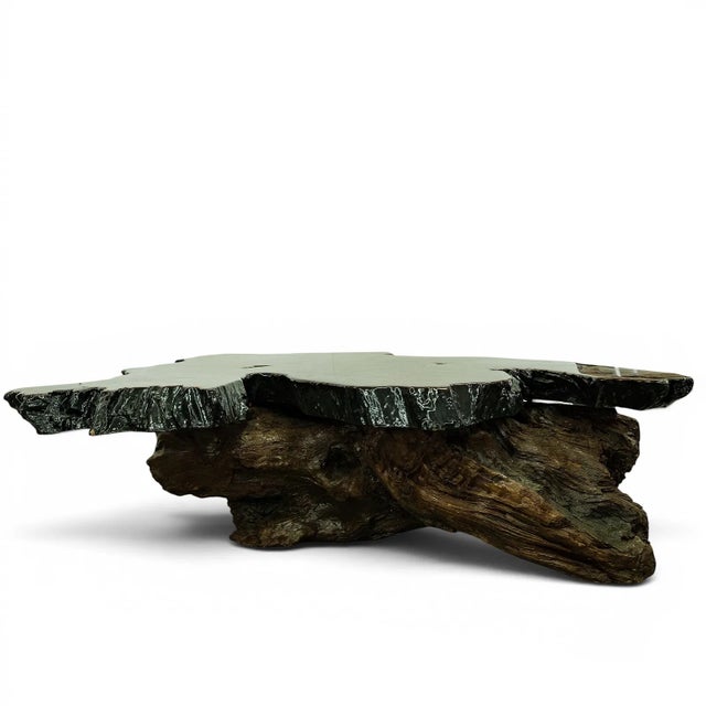 The 50 Inch Long 1970s Redwood Burl Coffee Table with Root Base is a stylish and unique piece of furniture that exudes a...