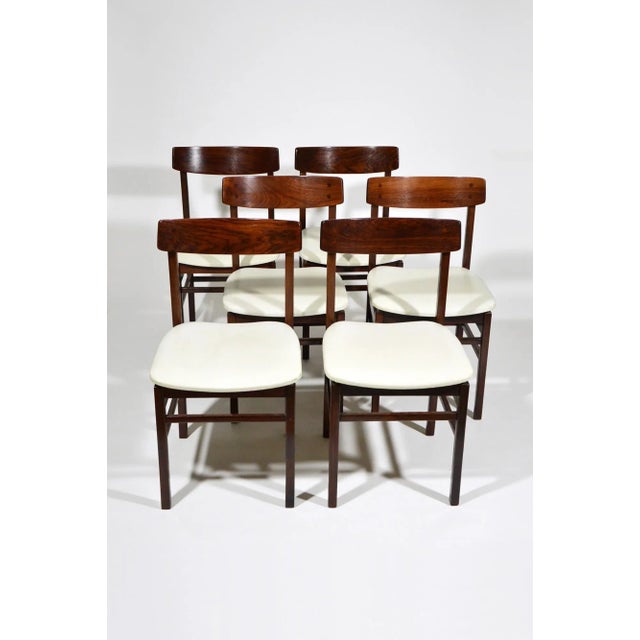 Set of 6 dining chairs in rosewood and ivory-coloured leatherette probably made in Italy in the 1960s, with essential,...