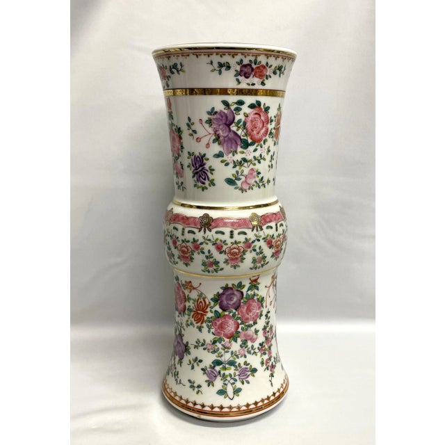 A tall English Adams Lowestoft vase in vibrant floral pinks, purple, gold and green. The hand-painted porcelain vase has a...