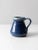 This is a vintage studio pottery pitcher dated 1988. The handmade ceramic ewer has a brilliantly rich blue glaze with pale...