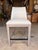 Contemporary counter stool featuring a clean, tailored silhouette upholstered in smooth light gray leather for a refined,...