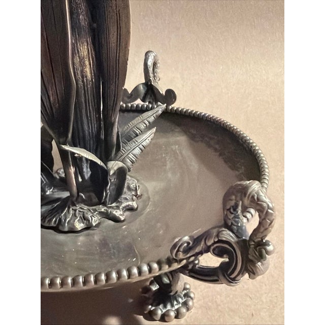 Unmarked, Victorian era silverplate base with handpainted trumpet glass center. Silverplate base shows one side has a...
