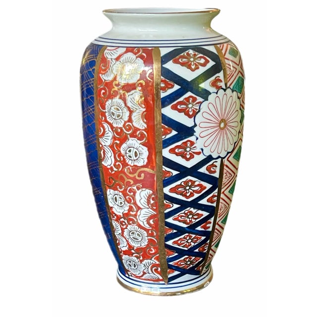 Hand painted Japanese Imari vase with graphic design in red, blue, ivory and gold. Unsigned.