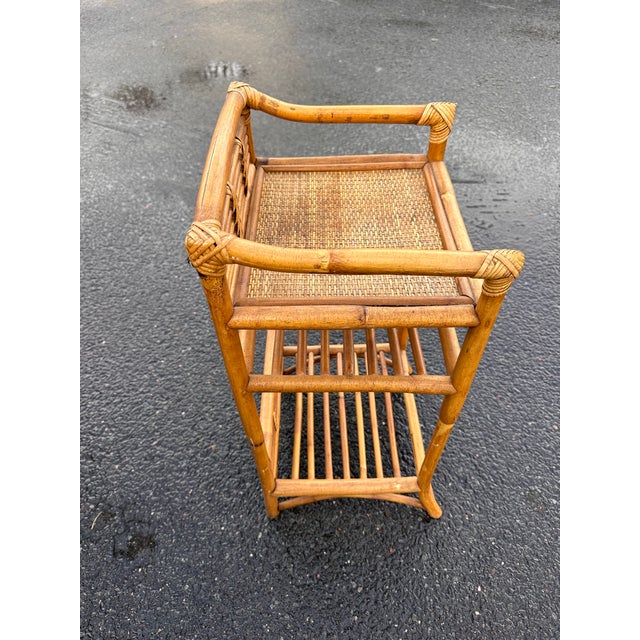 Frank Style three-level rattan book self with a hand-woven rice mat shelf on top and decorative stick rattan backplate...