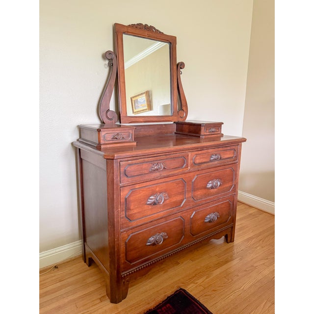 Stunning 1930s solid walnut Davis Cabinet Company chest of drawers with beautiful integrated carved walnut pulls in the...