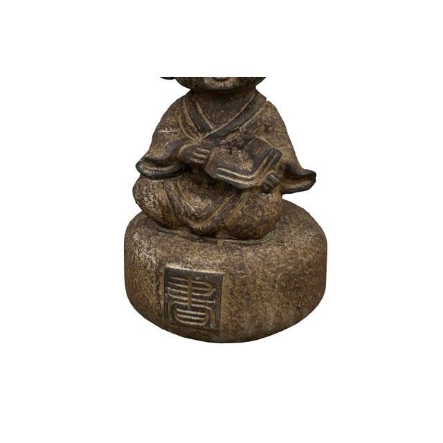 The Oriental Gray Stone Little Lohon Monk Reading Book Statue is a serene and captivating piece of artistry that exudes...