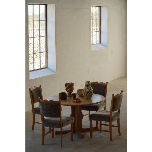 A charming set of eight Danish Mid Century Modern dining chairs crafted in oak, featuring a simple and timeless design...