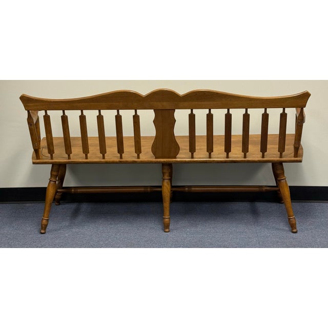 Beautiful vintage Early American Colonial Windsor style spindle back bench, made of solid maple and featuring turned legs...