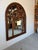 Exceptional large-scale wall mirror by John Richard, showcasing masterful craftsmanship in richly carved walnut. The...