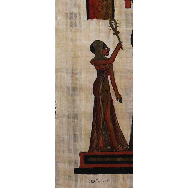 This captivating piece of Egyptian art, rendered on authentic papyrus, depicts a vibrant scene of pharaonic life....