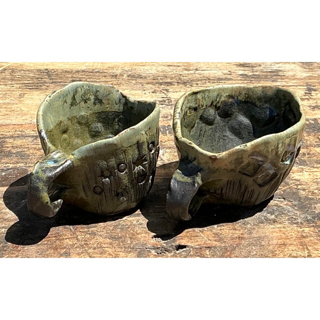 This distinctive pair of vintage studio pottery cups offers a tactile and soulful addition to any curated collection....