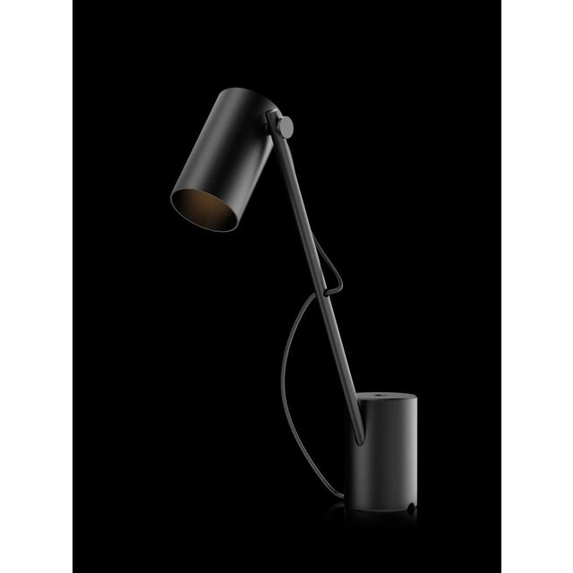 Reconfigurable table lamp with black paint structure and black paint base. Thanks to the two holes on the base, the lamp...
