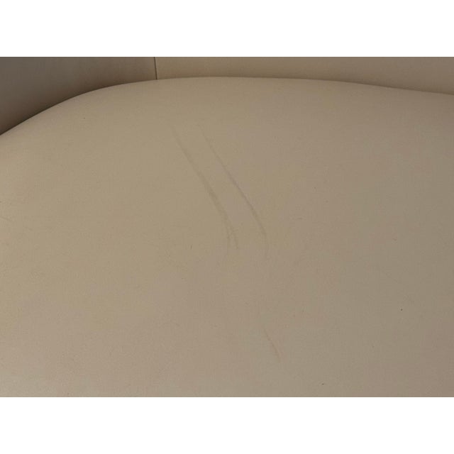 Discontinued Gwyneth loveseat from the CB2 x goop collaboration, upholstered in ivory leather. The sculptural silhouette...