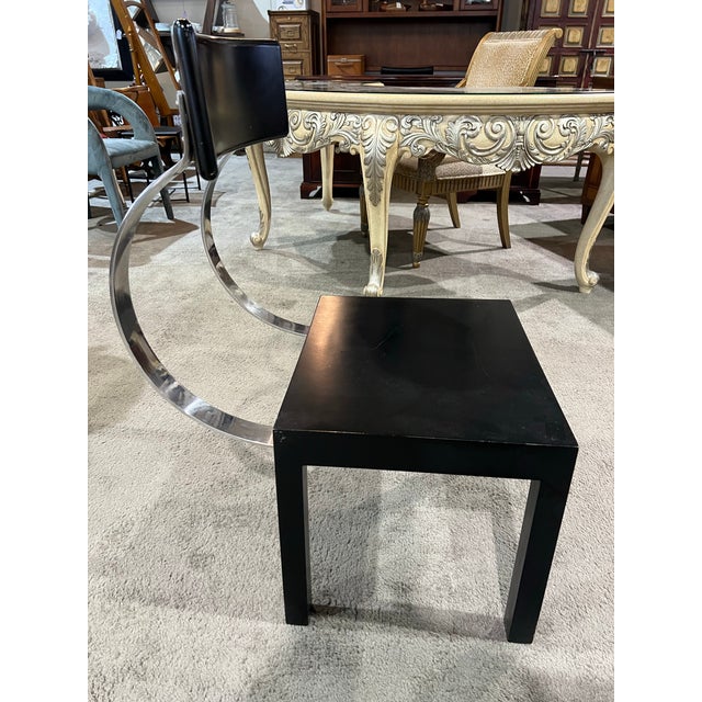 This striking accent chair showcases a bold interplay of clean lines and mixed materials, offering a distinctly modern...