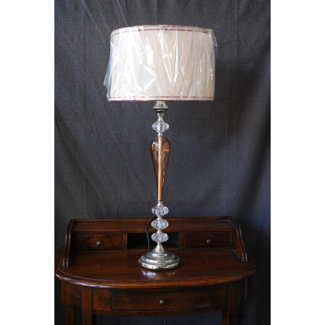 Redew Lamp: An imposing and elegant lamp, a blend of ancient and modern. The large, round shade is pure white with...