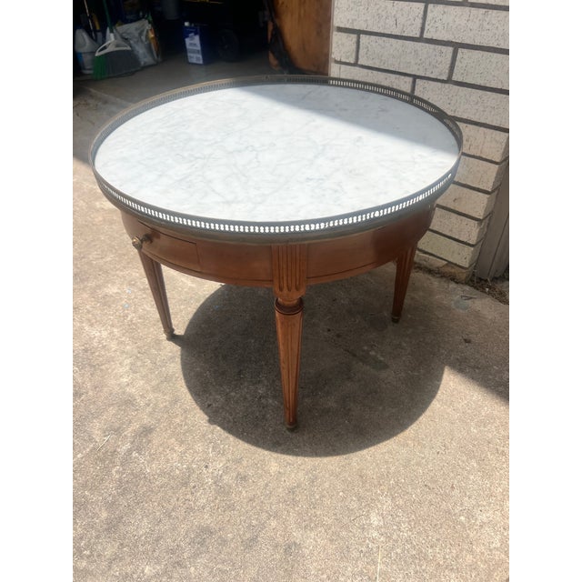 Elegant French Louis XVI side table crafted in walnut with a beautifully figured veneer. It features a single drawer, a...