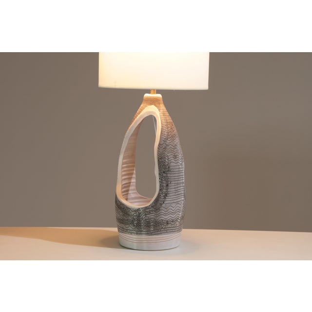 Elegant and sculptural, this openwork lamp by Jean Austruy perfectly illustrates the refined craftsmanship of the French...