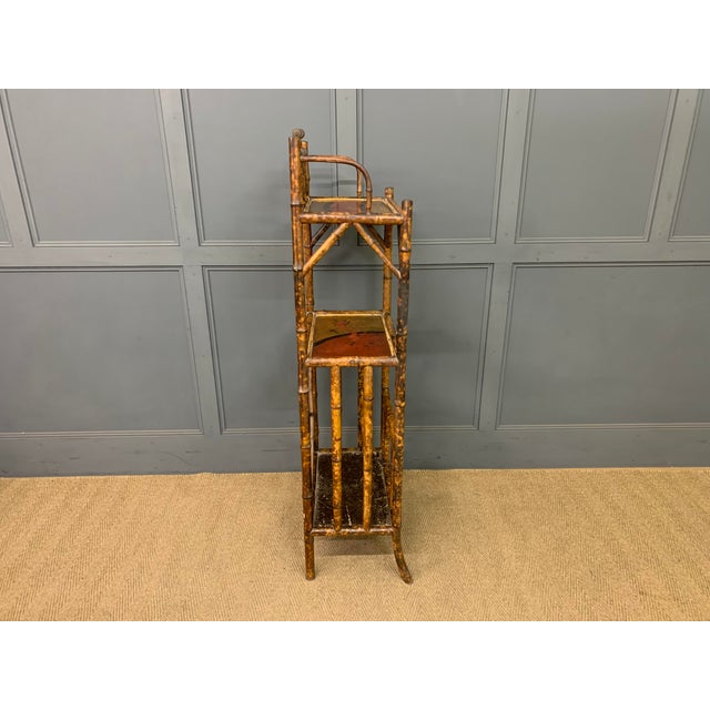 A lovely decorative Victorian period bamboo canterbury whatnot. Well constructed in bamboo with decorative lacquered...