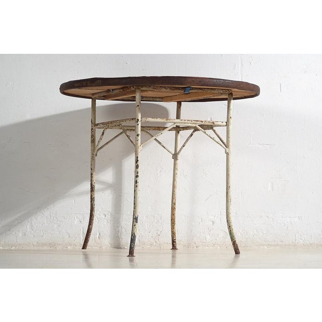 Antique outdoor round table in metal and wood (France, c.1900). Approximate age: 120 years Material: Iron and wood Origin:...