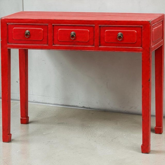 This is a mid-century Chinese export red lacquered altar style console table. The piece is lacquered hardwood with three...