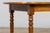 An inviting antique French farmhouse dining table crafted in warm fruitwood, likely cherry, and sourced in Provence....