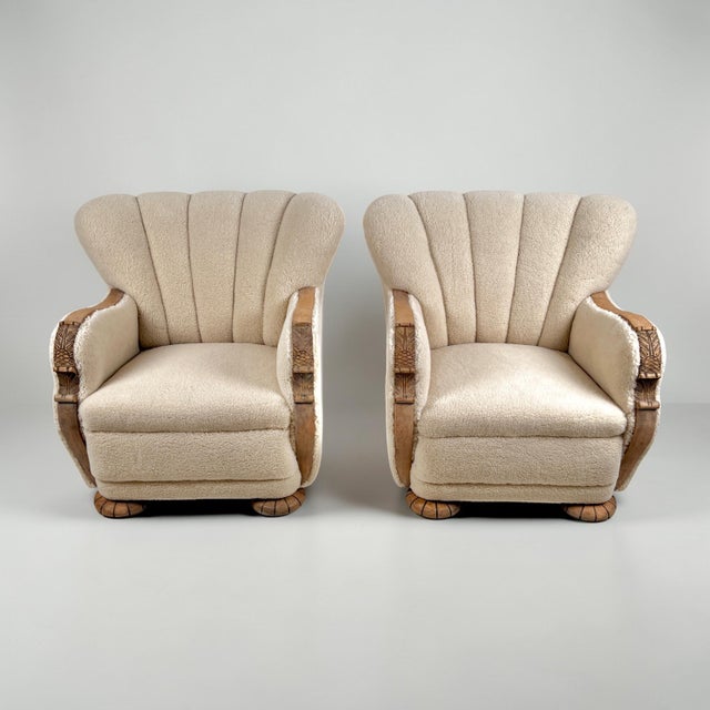 A rare pair of Danish Art Deco armchairs of generous proportions, retaining their original scallop-form backs and...