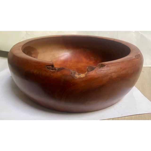 This is a great looking well made hand carved bowl made of red wood and having an overhanging edge. It has a wonderful...