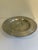 Striking vintage hand-wrought aluminum lazy Susan featuring a raised pedestal base, rotating tray, and an elegant embossed...